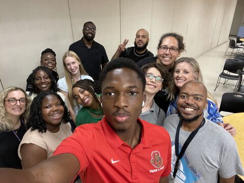 Ayotunde Ejiko taking a group selfie with colleagues on the DCPS Becoming Team